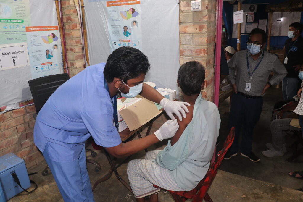 Medical staff administer vaccine to a patient