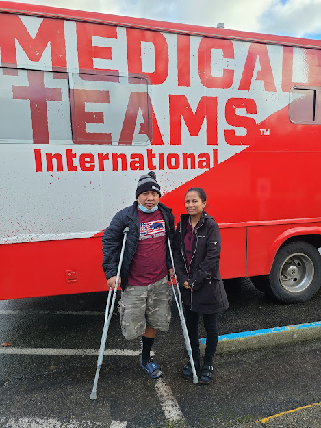 couple standing in front of Medical Teams dental van