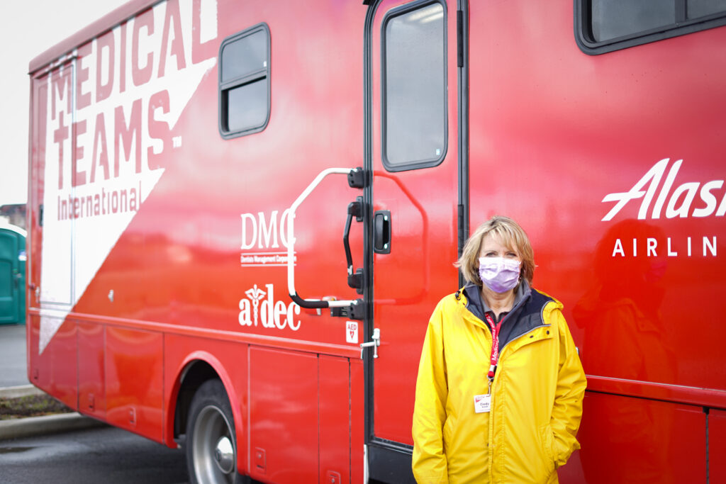 Cindy Breilh, Medical Teams Executive Director, US Programs, stands in front of a Care & Connect Vehicle in Issaquah, WA.