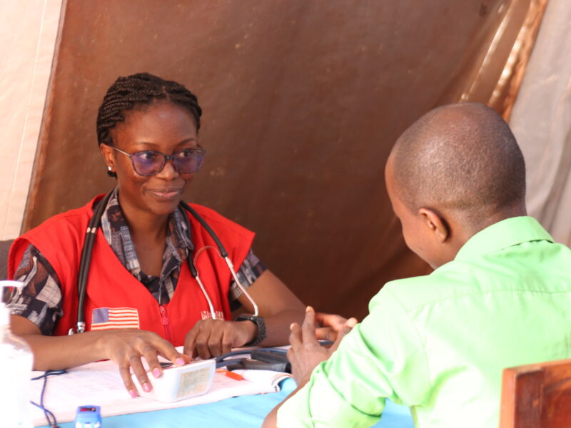 Dr. Eddah listens to a patient.