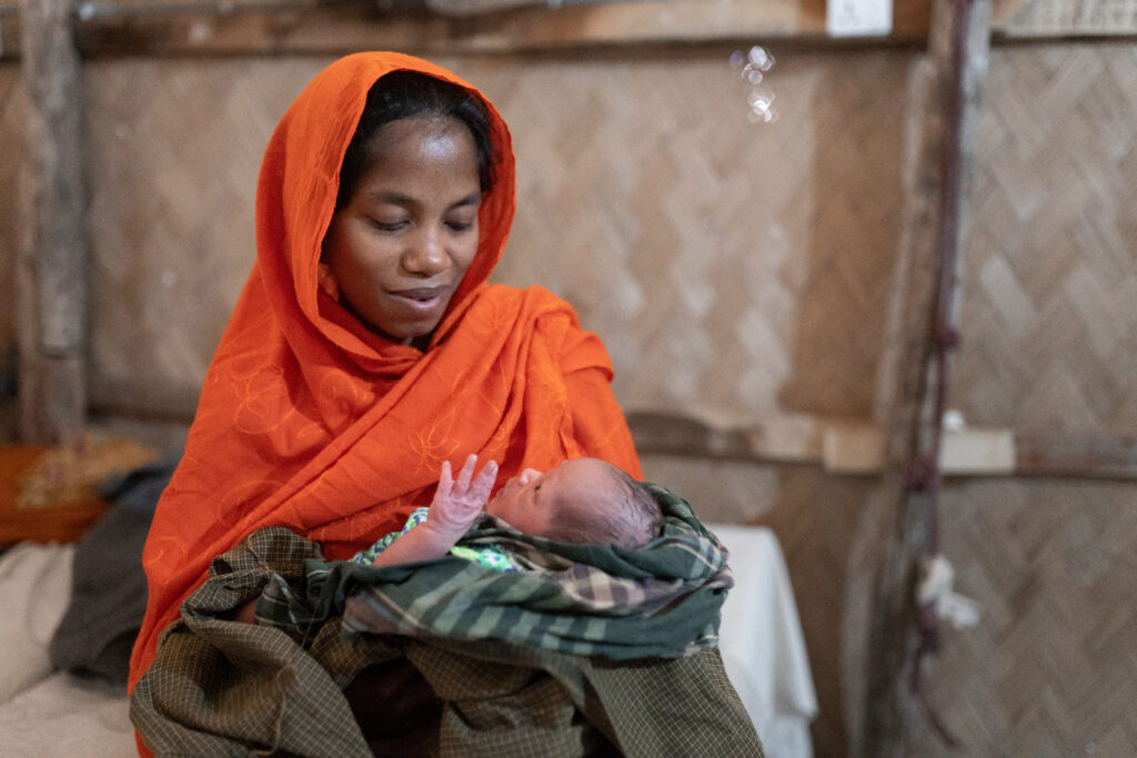 A mother holding her baby