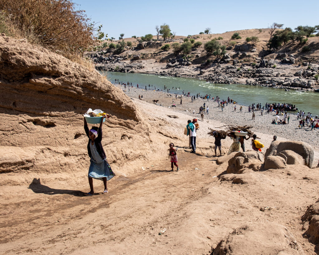 Ethiopian refugees crossing the river into Sudan