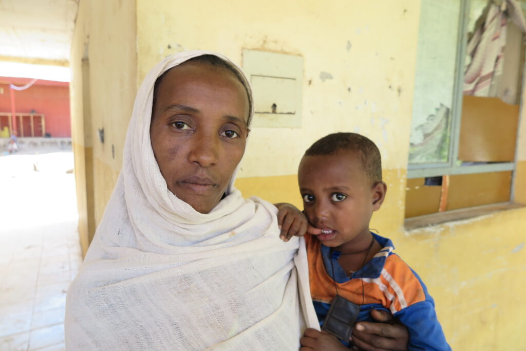 A mother holds her child inside a Medical Teams clinic.