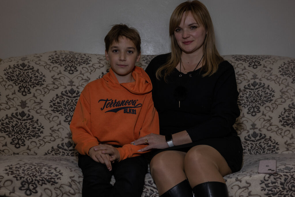 Ukraine photo: a mother and son sit on a couch
