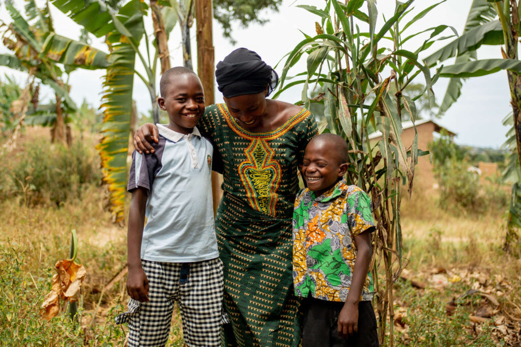 Florance stands with her arms around her two young sons and laughs.