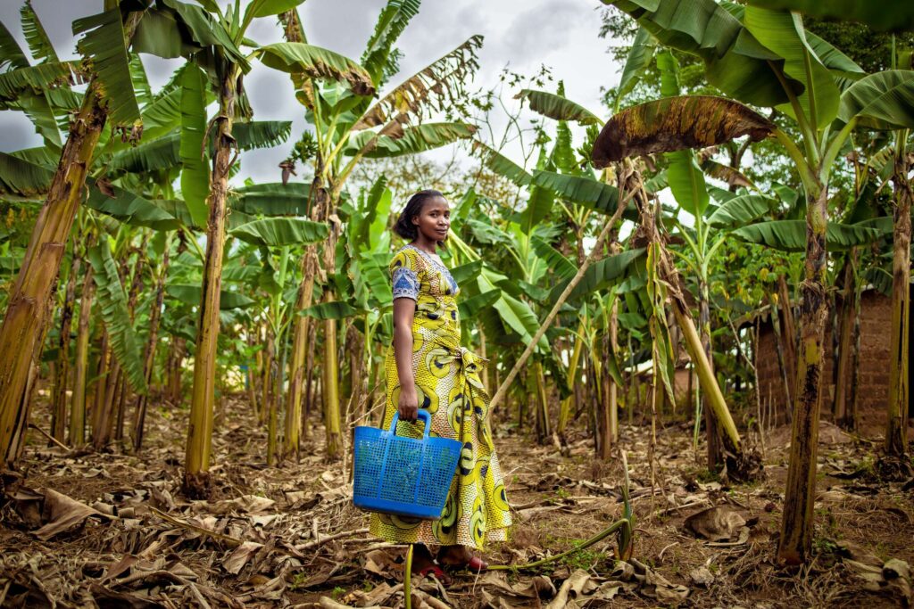 Florance stands among her crops in her backyard.