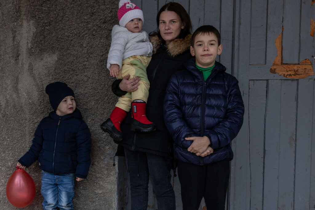 A mother poses with her three children