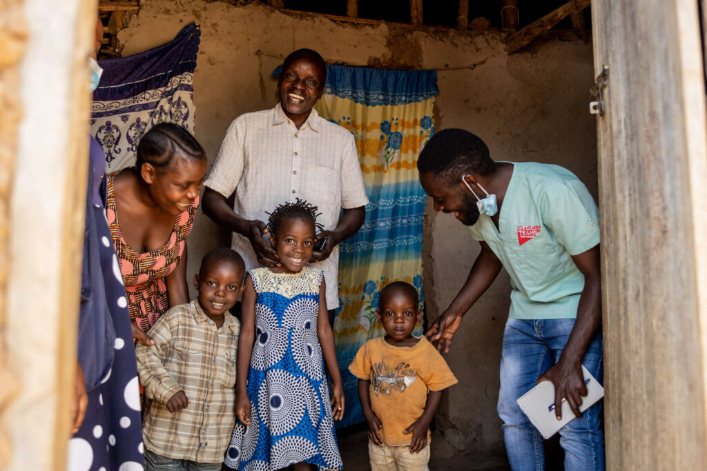 Dr. Salim, a Ugandan psychiatrist, smiles with Obedi's family.