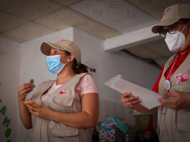 Two Medical Teams staff speaking to a group