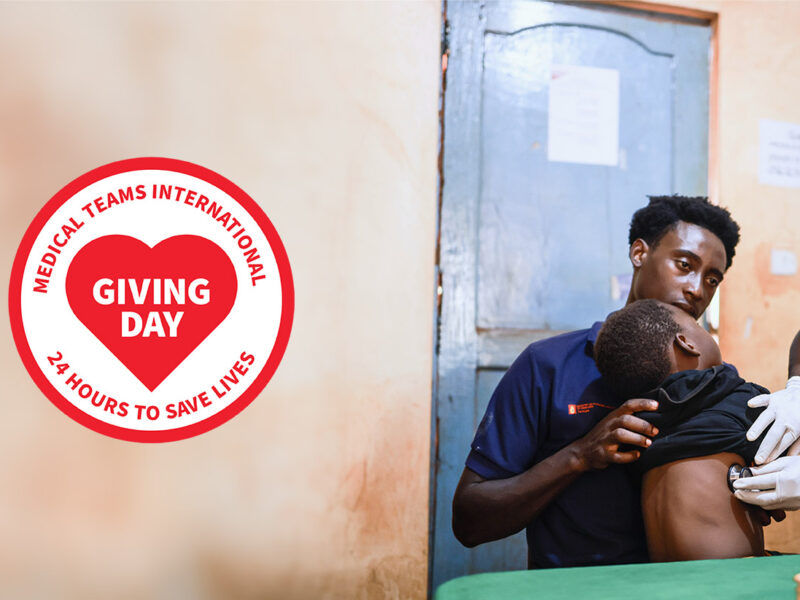 A doctor checks a young child's breathing with a stethoscope in Tanzania.