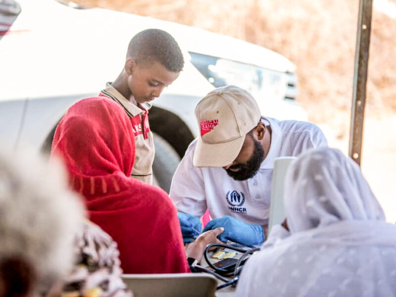 Mobile medical team staff with patient in Um Golja internally displaced by the conflict in Khartoum