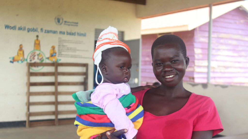 A woman holds her young baby