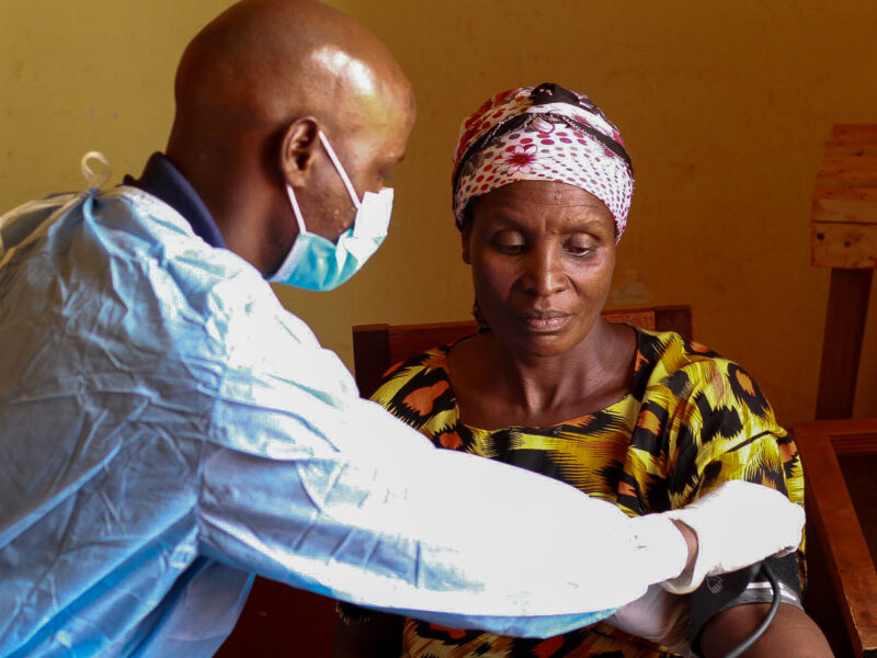 Bapfumukeko at clinic receiving medical care from doctor with mask.