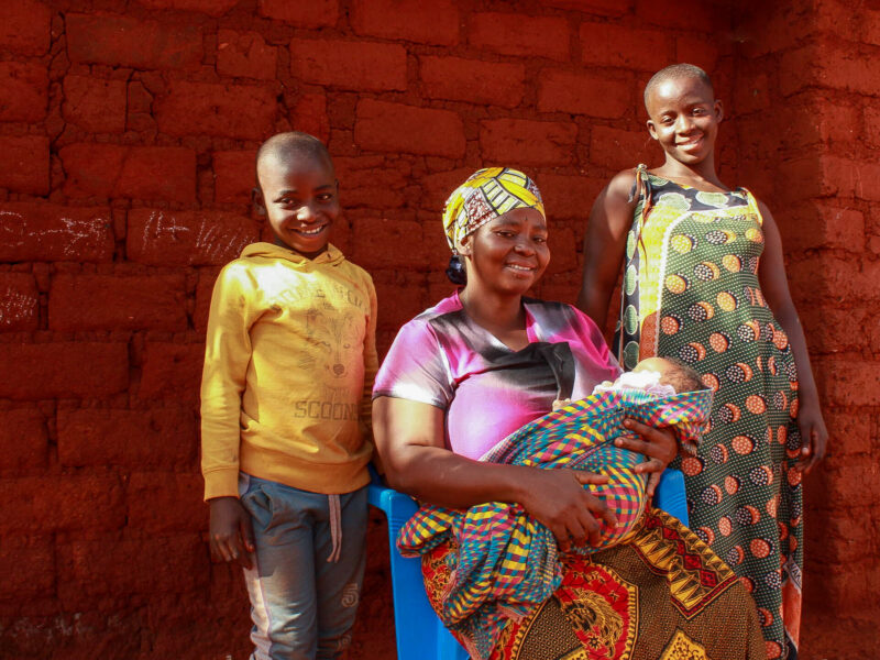 Bikorimana with her children smiling. Maternal Health story.