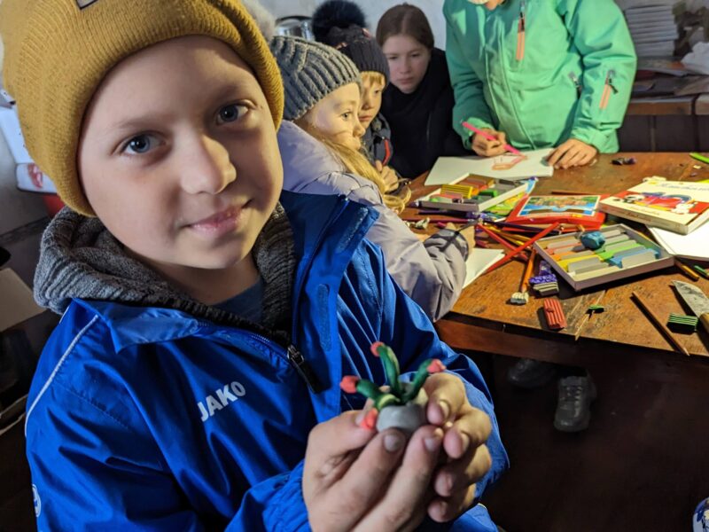 Nadiya's son Denis Shows off his artwork he made at the mobile medical setup location.