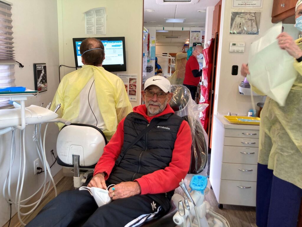 A patient sits in a dental chair in the U.S., one of the 7 countries we serve in