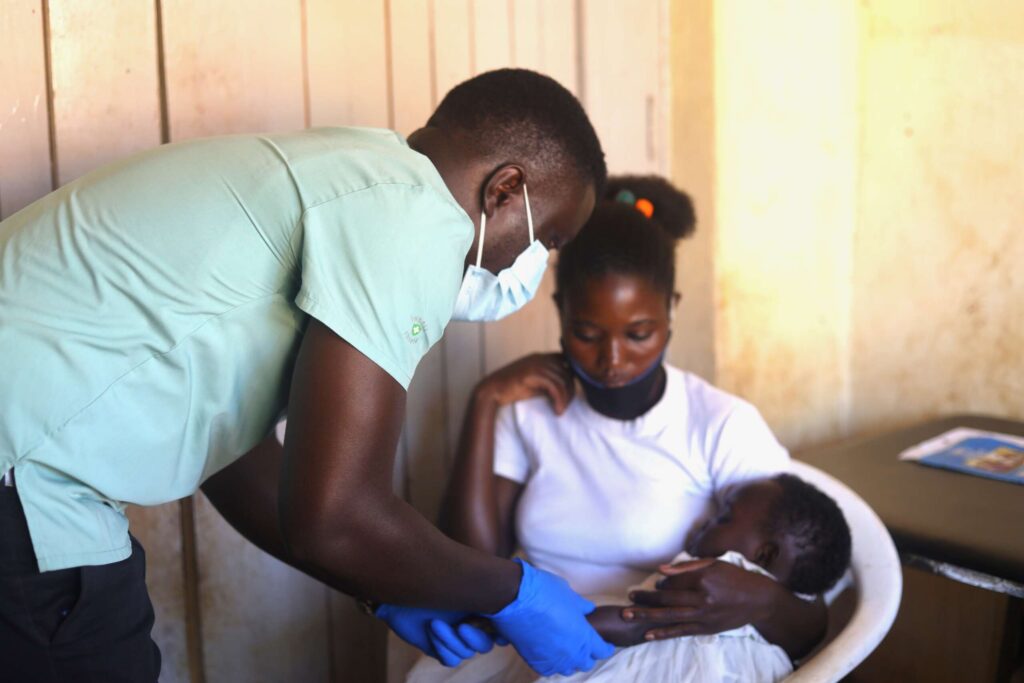 A male nurse helps a child