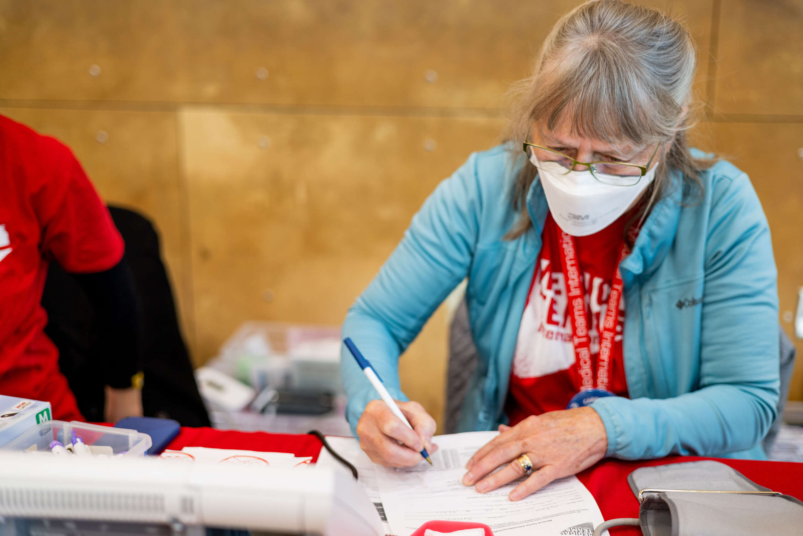 USA Volunteer Bess captures the blood pressure information for a patient at the Kaiser IRCO clinic 2023