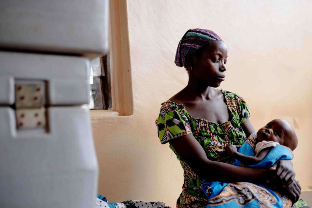 Eva, a mother in Uganda, looks at her son Meshake