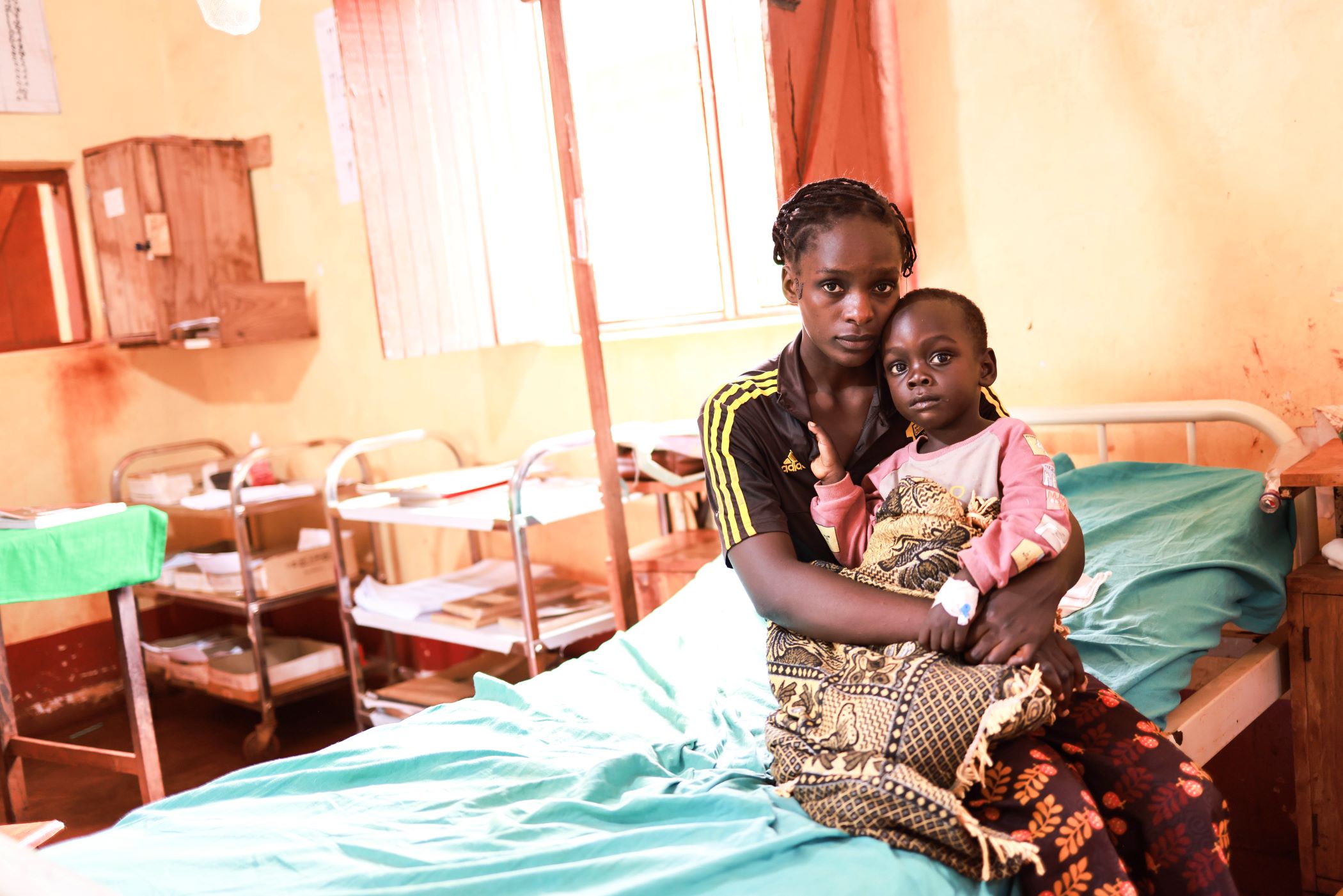 Nibizi sits with her son Niyukuri in a clinic