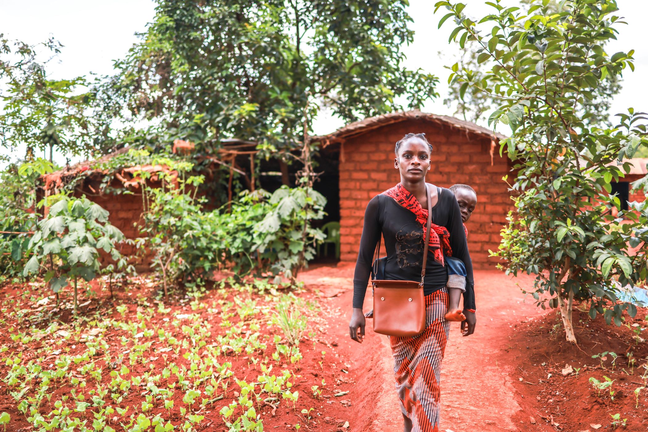 Nibizi carrying her son Niyukuri to the hospital in Tanzania