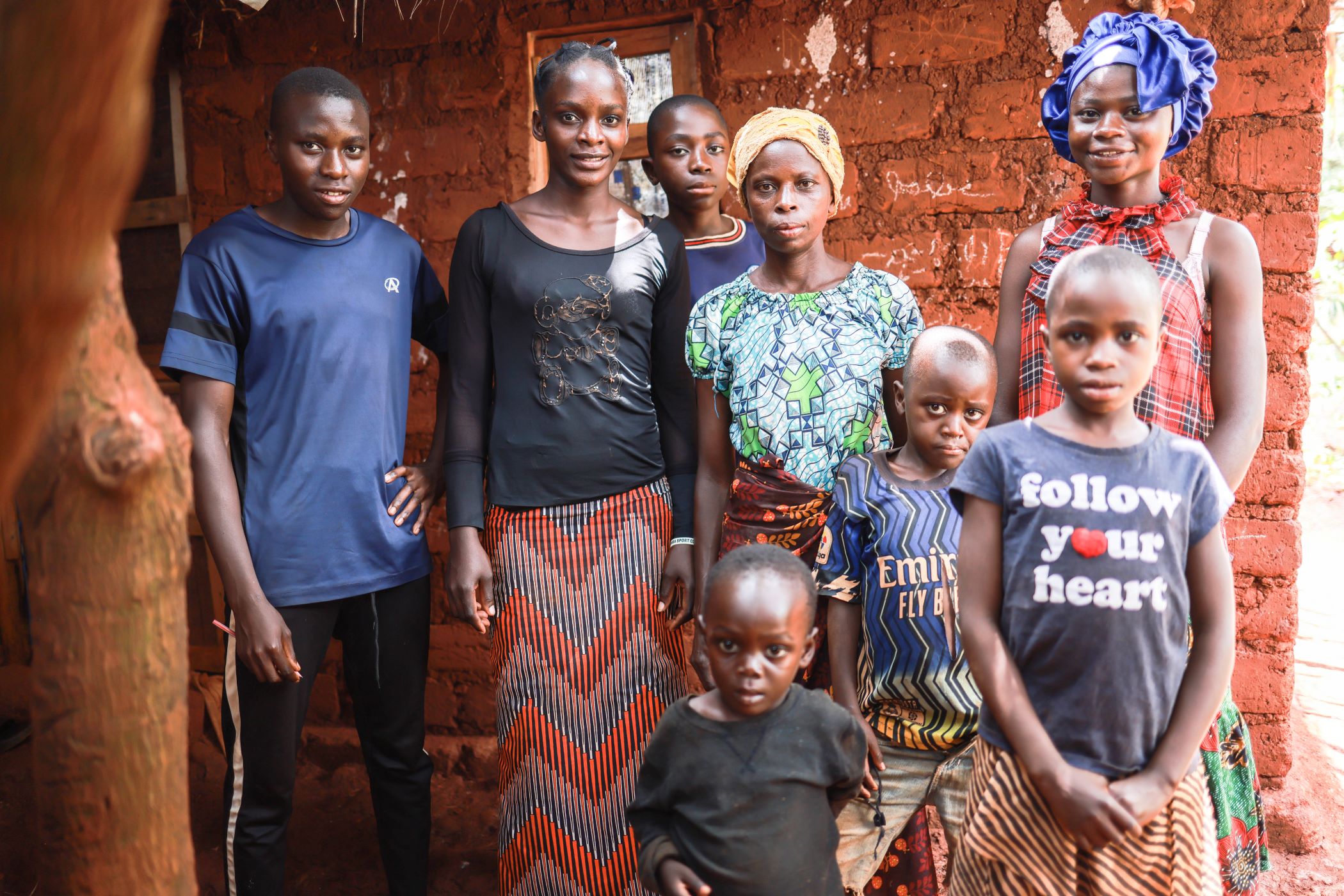 Niyukuri's family stands outside their home in Tanzania
