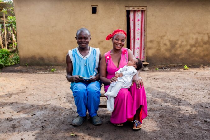 Janet and her husband Gallas sit with their newborn in Uganda