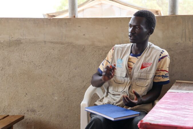 A Uganda staff member explains to newly arrived patients the process for the day