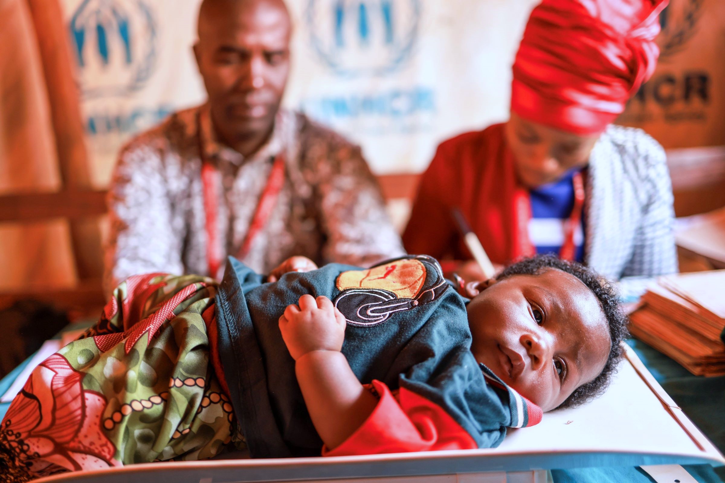 A baby is weighed for nutritional monitoring in Tanzania