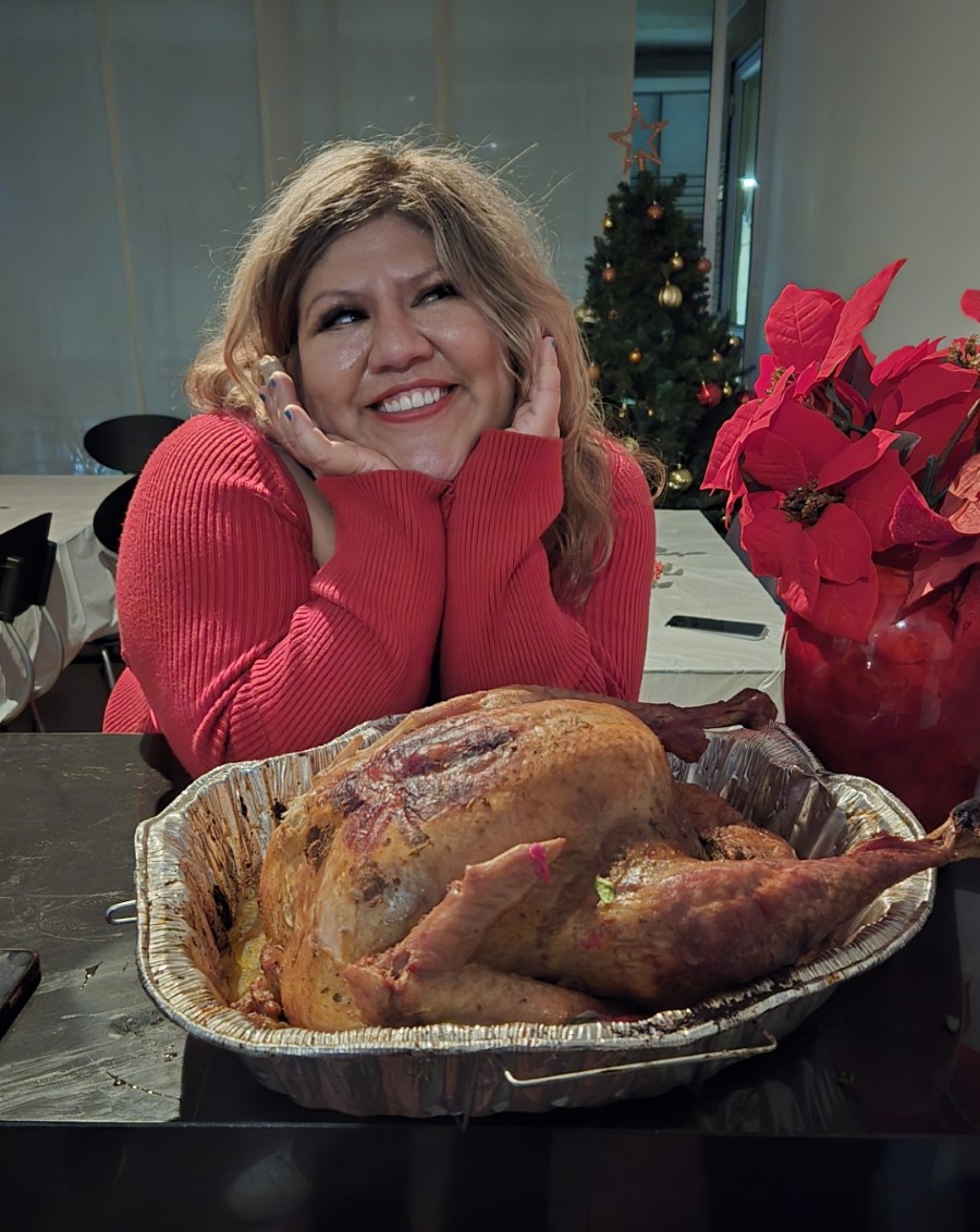 Bessie smiles by a Salvadoran-style turkey