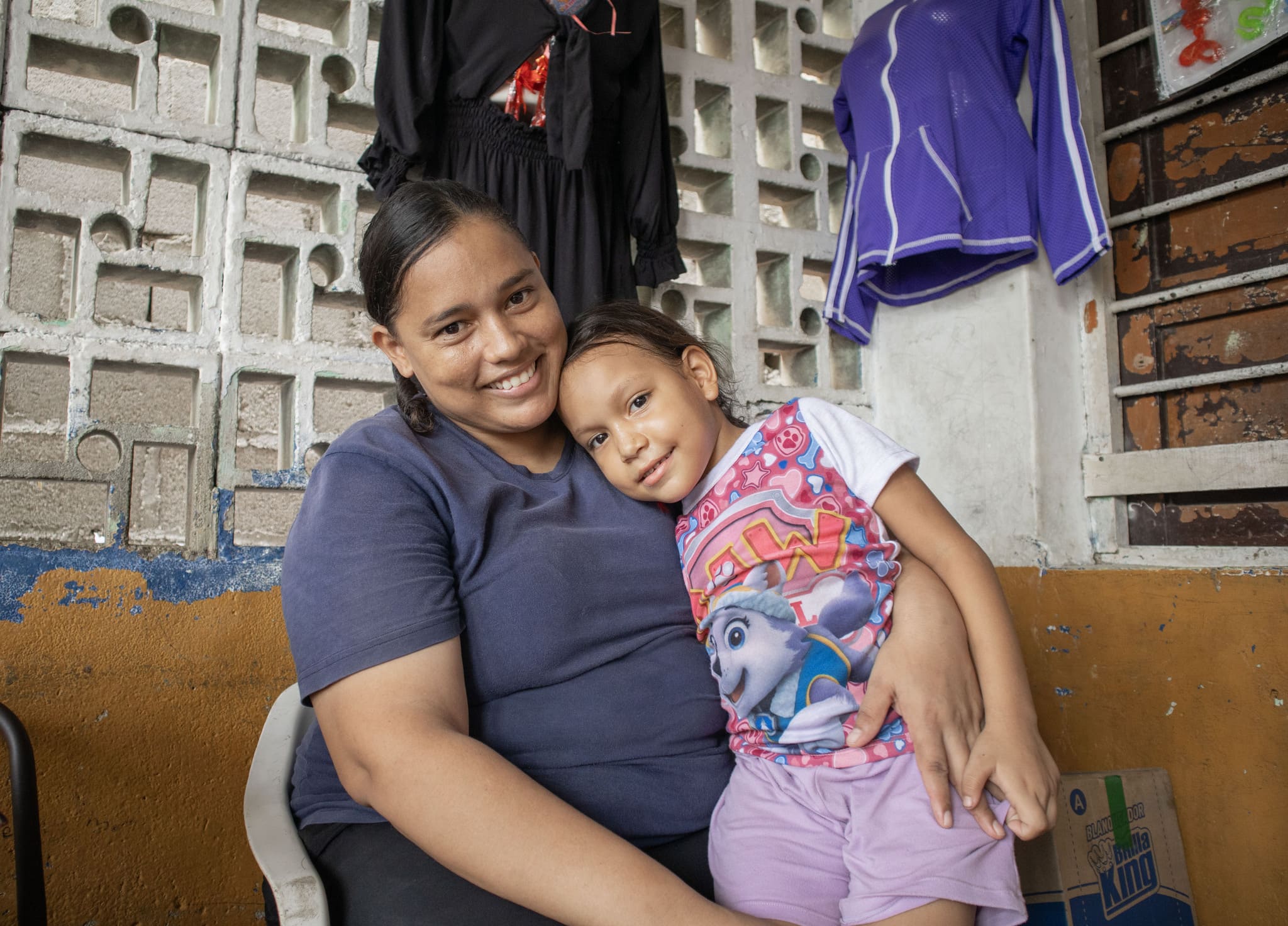 Naylin embraces her daughter Ashley in their home in Santa Marta, Colombia