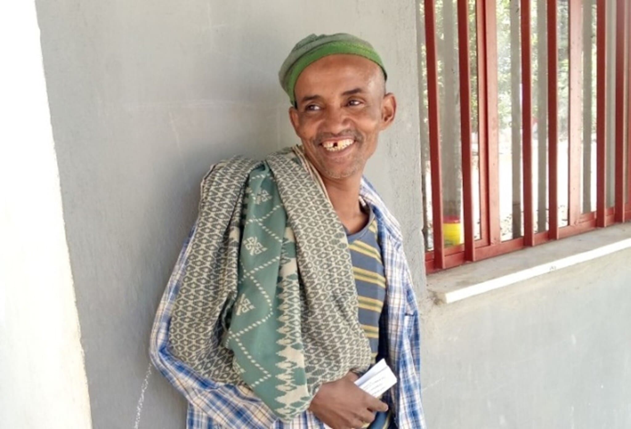 Adem Mersha smiling outside in Ethiopia