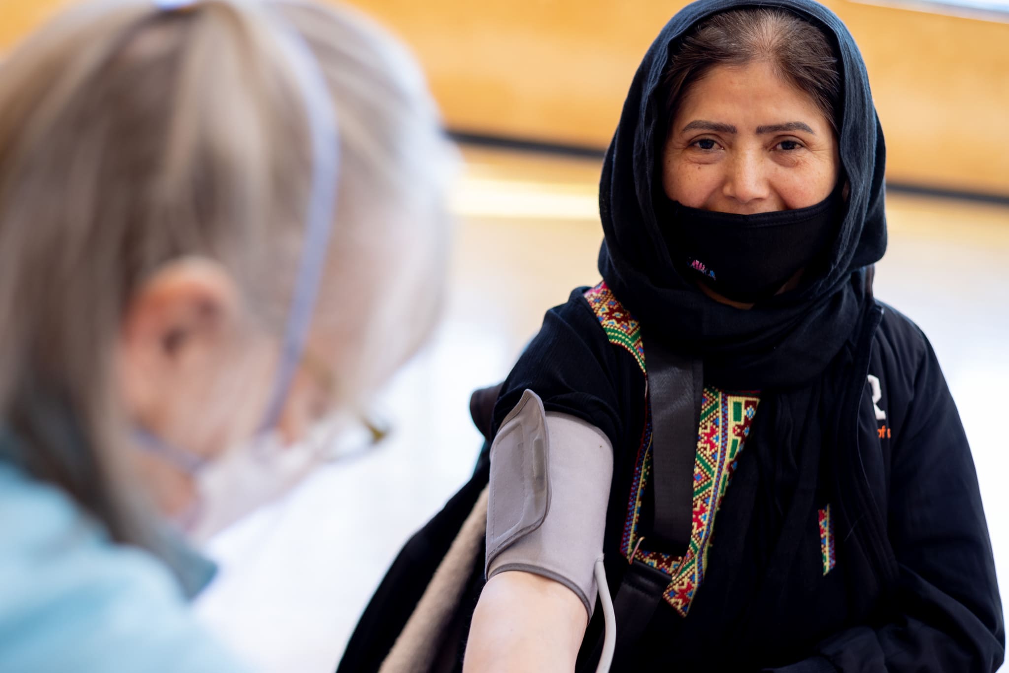 Fatima gets her blood pressure checked by a nurse in Portland Oregon
