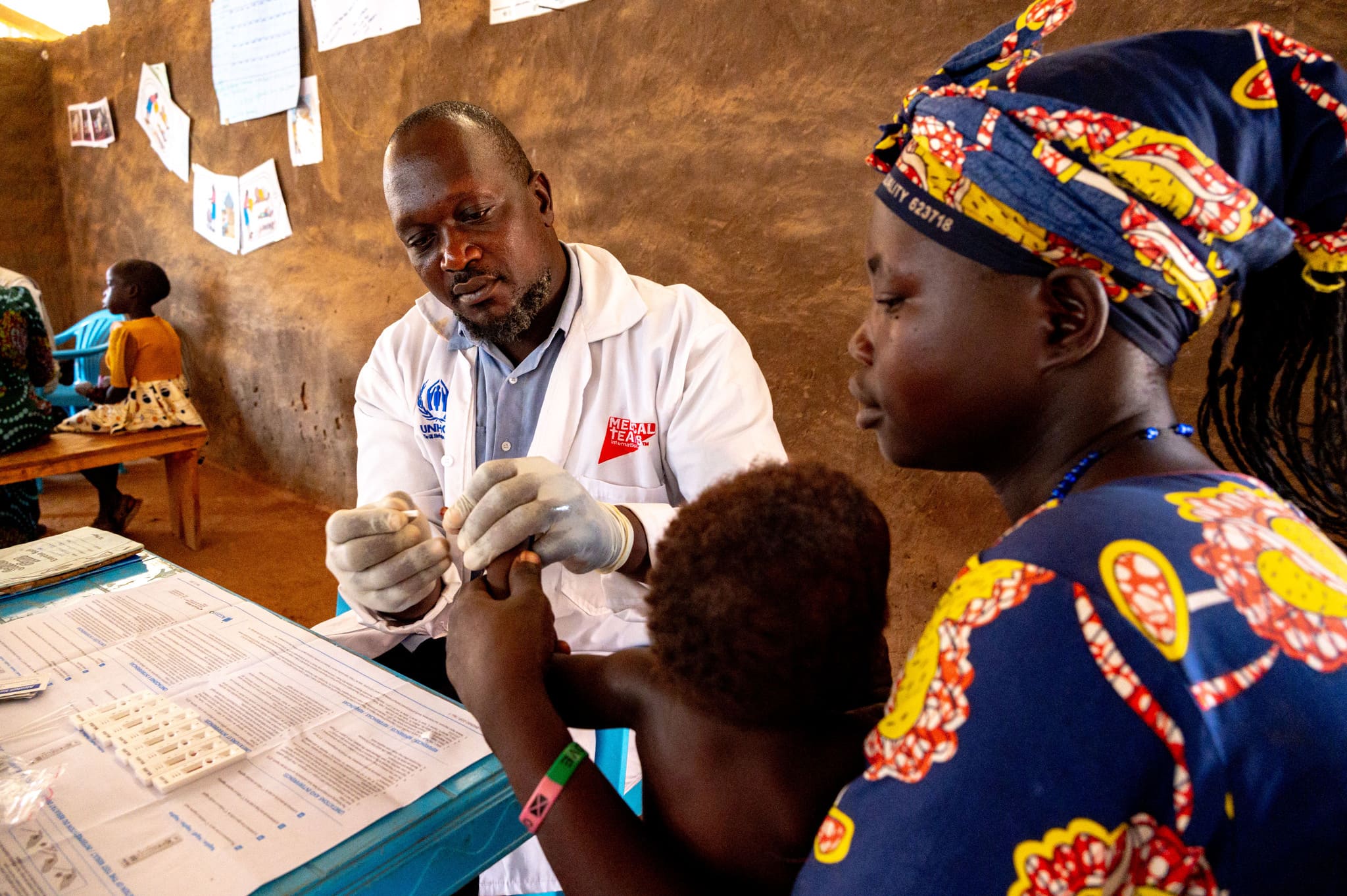a child receives medical care in a clinic in Uganda