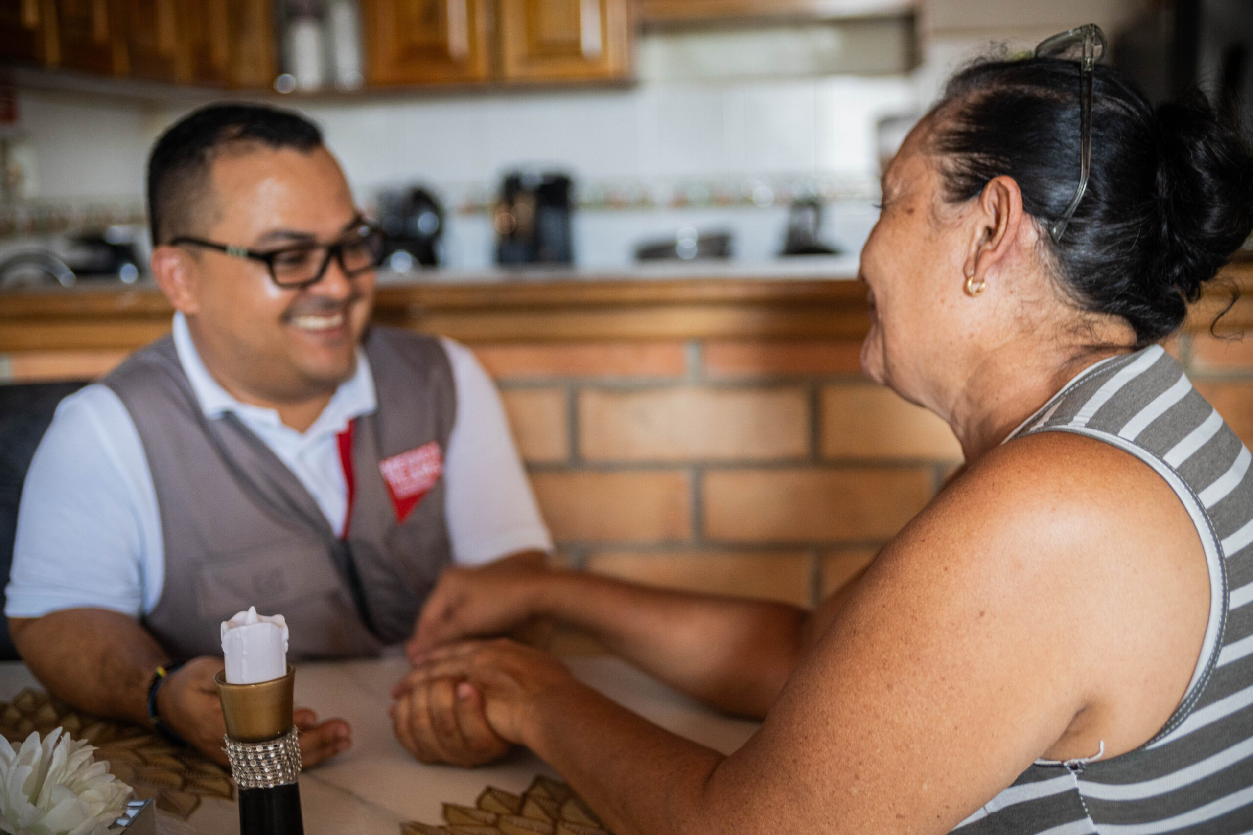 Medical Teams volunteer Martin talking to Morelba in her home.