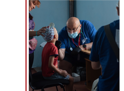 Medical Teams staff examines a young boy during a consultation.
