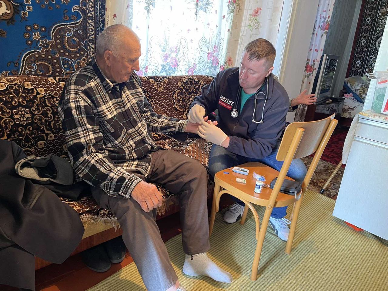 Mykhailo receiving care in his home.