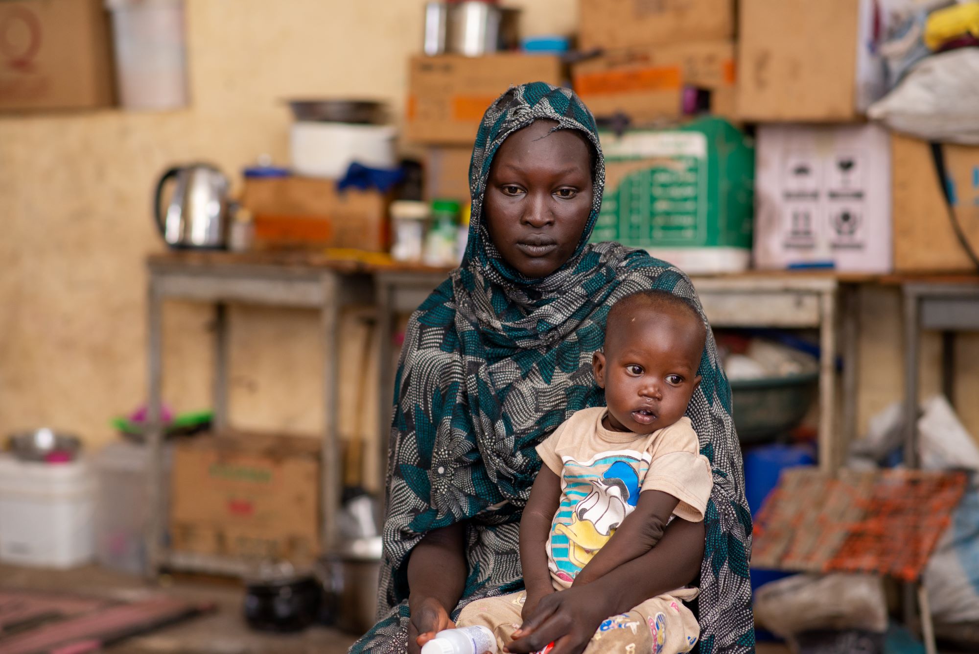 Fatima sits with her son, Ramadan in a Medical Teams clinic in Sudan