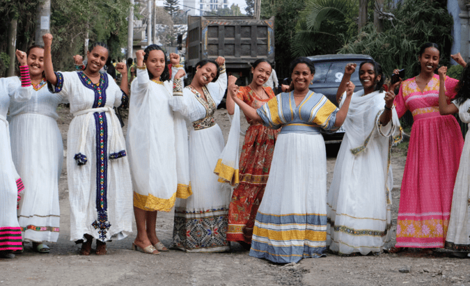 A group of Ethiopian women holding up the Accelerate Action pose