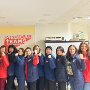 Medical Teams staff members in the accelerate action pose for International Women's Day