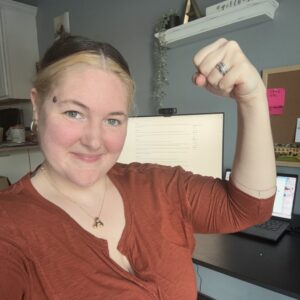 Medical Teams staff member in the accelerate action pose for International Women's Day