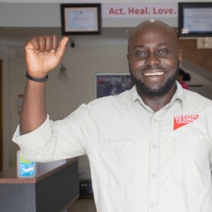 Medical Teams staff member in the accelerate action pose for International Women's Day