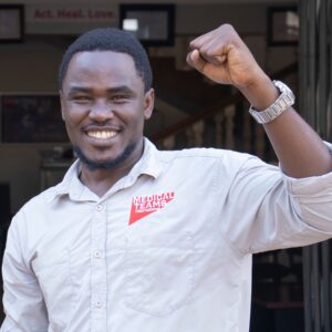 Medical Teams staff member in the accelerate action pose for International Women's Day