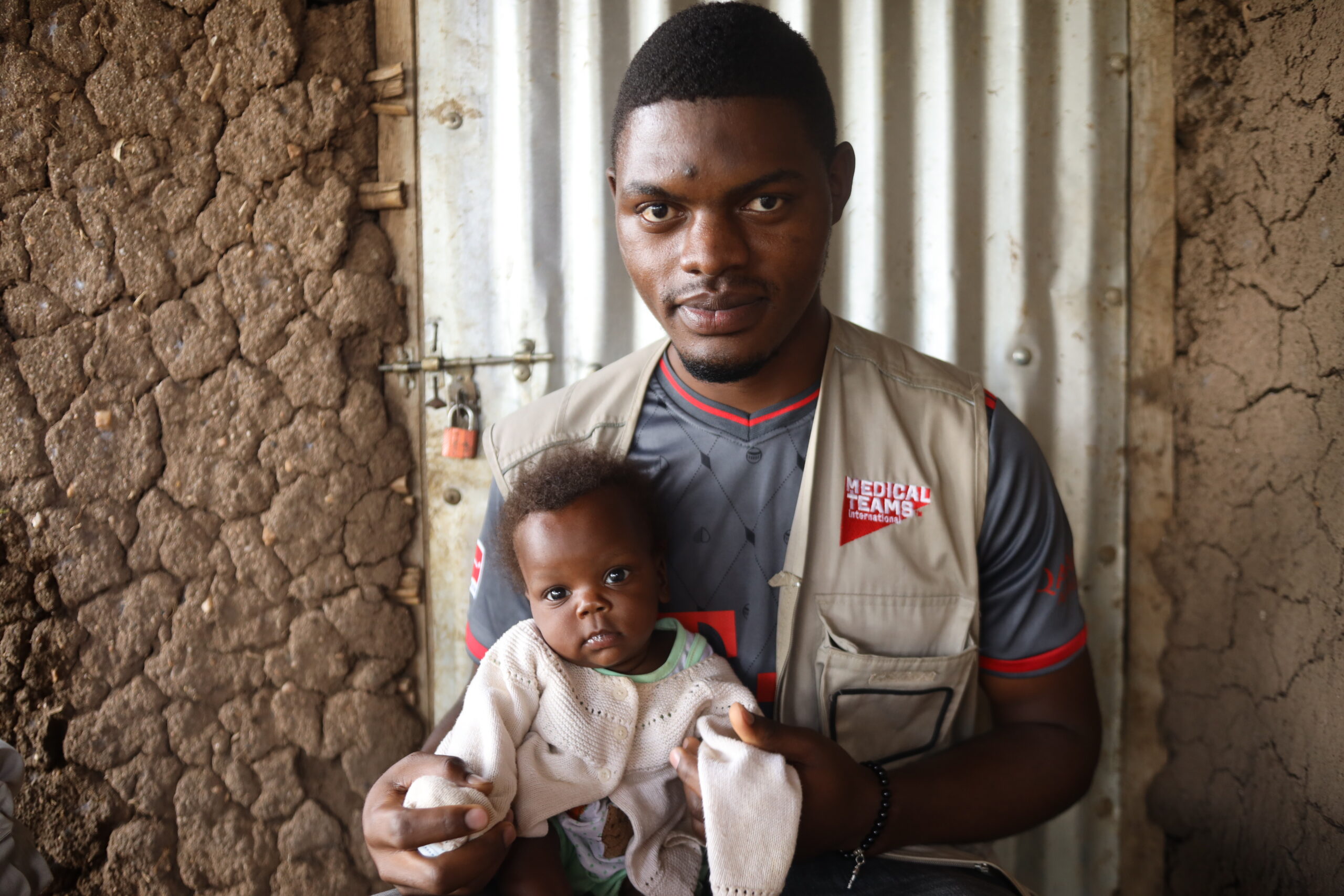 Musa, one of Medical Teams' nutritionists holds one of the triplets. 