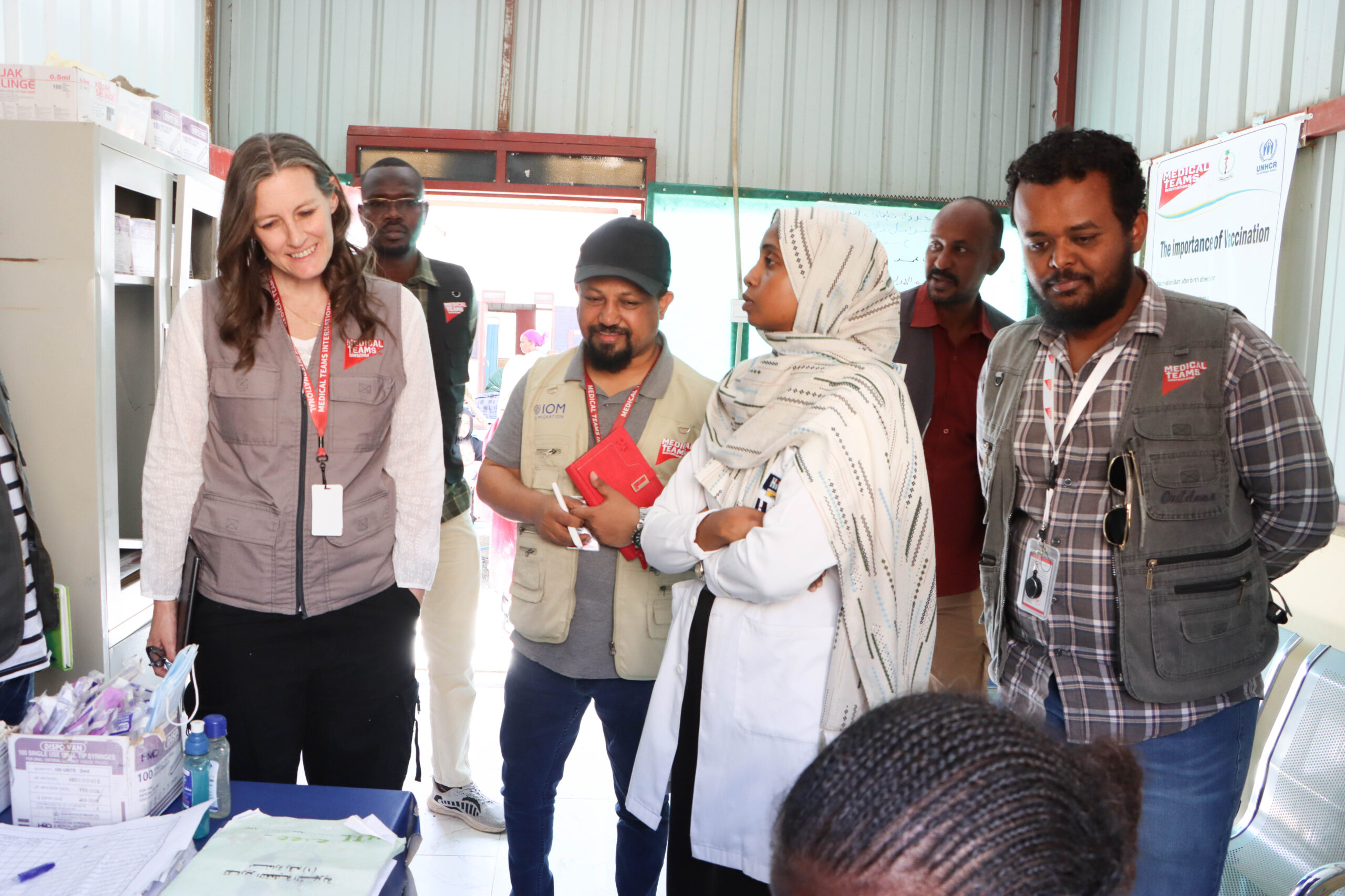 Sudan Country Director Birhanu Waka (pictured in center, with cap) accompanies Chief of Global Programs Lauren Taylor and other staff on a tour of a clinic. 