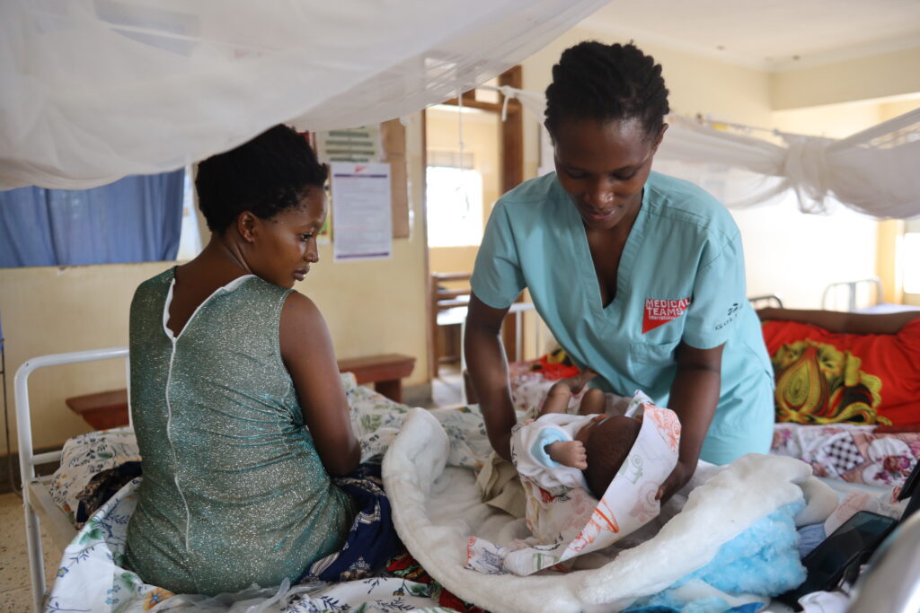 Patient Devota Tumusifu being supported by Daphine at Kasonga Health Center.