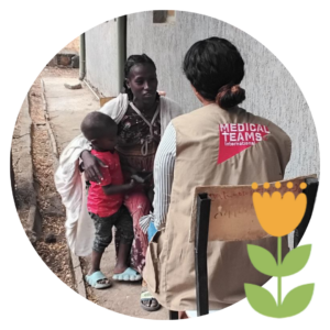 Portrait of Wubeya Asresa and her son speaking with a Medical Teams worker. 