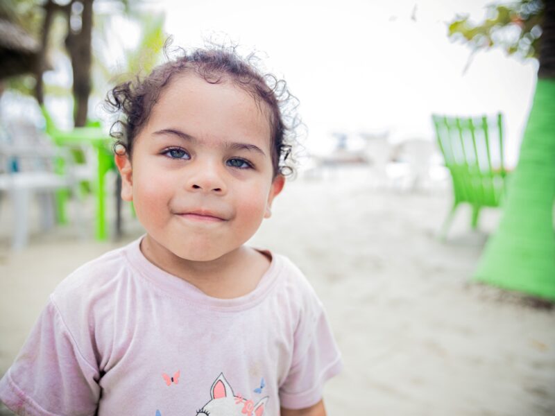A girl named Alaia standing outside on Necocli Beach, Colombia
