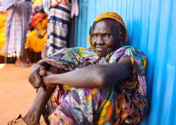 A woman sits outside the health clinic in Ethiopia