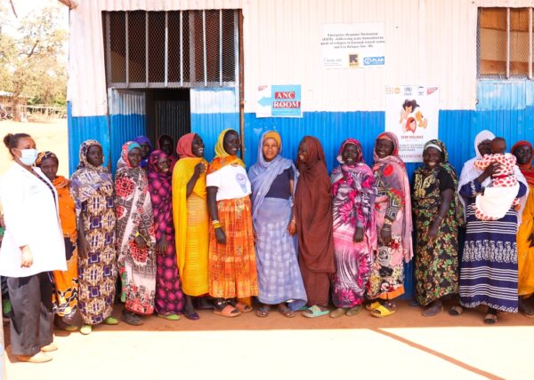A group of women smile and laugh together outside the maternal health ward in Ethiopia